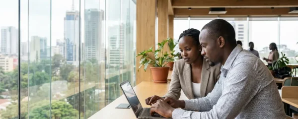 Business professionals in EOR discussion at modern African office environment